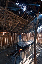 Traditional salt making - brine is boiled in a large open pan over fire of palm fronds for 8hrs, East Timor, August 2010.
