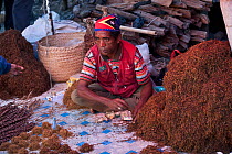 Market vendor sells loose tobacco, Maubisse, East Timor, August 2010..