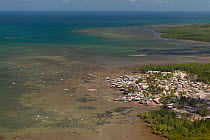 Aerial view of highly populated region of Puerto Princesa coastline with outrigger boats and houses, Philippines, April 2010.