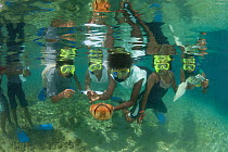 Mahonia Na Dari (Guardian of the Sea) teacher Lorna Romaso leads a group of 16 students to snorkel and learn about the reef. West New Britain, Papua New Guinea, May 2010.