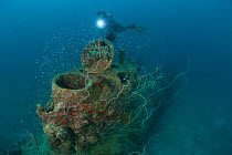 Diver at Japanese mini submarine wreck 50 meters away from the Sanko Maru wreck in New Hanover, New Ireland, Papua New Guinea, June 2010.