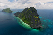 Aerial view of island with steep limestone cliffs,   birds' nests amongst the caves are highly protected or guarded for their commercial value in the Chinese market, Palawan, Philippines, May 2009.