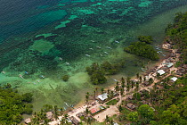 Aerial view of coastal island community with outrigger boats on sandy beach, Palawan, Philippines, May 2009.