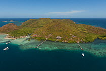 Aerial view of private island resort with yachts anchored at the jetty and Mangroves along the coast, Palawan, Philippines, April 2010.