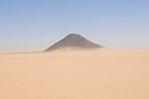 Desert landscape seen from the air with solitary mountain rising from the sand. Termit Massif, Niger, Africa.