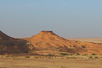 Desert landscape with flat-topped hill. Termit Massif, Niger, Africa.