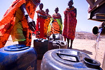 Samburu women in northern Kenya village of Kiltamany wait in line to fill their jerry cans from a drought relief vehicle. The worst drought (2008-2009) in more than a decade has killed most of their l...