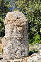 Bronze age granite statue menhir at Filitosa, carved c 3,500 years ago, with grumpy face. Corsica, France, June 2010.