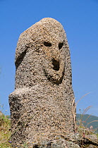 Close up of Bronze age (c 3,500 year old) granite statue menhir standing stone at Filitosa with carved face. Corsica, France, June 2010.