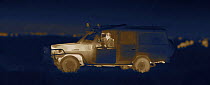 Martin Dohrn in night filming vehicle, on location for National Geographic Nightstalkers, Topi Plain, Masai Mara, Kenya. Image taken using a thermal camera, without artificial light. *THIS IMAGE CAN O...