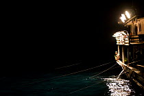 Purse seiner with thousands of watts of lights which remain on for 3 straight hours to attract fish. These vessels are very effective at targetting schools of fish that aggregate near the surface of t...