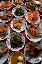 A restaurant in Wanci. The servers brings out all dishes to your table and you eat what you want and pay for what you've eaten. Each table looks like a feast. Wakatobi, Sulawesi, Indonesia, November 2...
