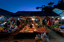 Late afternoon market selling everything from fresh fish and vegetables to cooked meals ready to serve for dinner. Wakatobi, Sulawesi, Indonesia, November 2009.