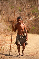 An indigenous Mangyan man walking from his village to town, a journey that may take a few hours. Calintaan, Mindoro, Phillipines, March 2010.