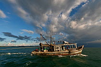 Trawler boat trawling Kudat Bay. Delicate coral reefs that take centuries to grow are demolished by fishing gear like trawl nets that rake the ocean floor. It's the marine equivalent to clear-cutting...