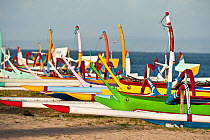 Brightly painted local fishing boats in Bali which still use traditional sails. Bali, Indonesia, July 2009.