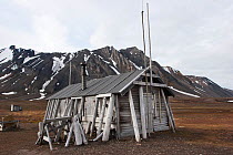 Old trappers hut situated on the shore. Bamsebu, Bellsund, Svalbard, July.