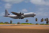 A Royal Australian Airforce Hercules C-130 taking off with vortices visible from the propeller blades.  Cocos-Keeling Island group, Australia, the Indian Ocean, November.