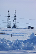 Gas drilling derricks and power cables at Sabetta in the Tambey gas field, Yamal Peninsula, Western Siberia, Russia, March 2011
