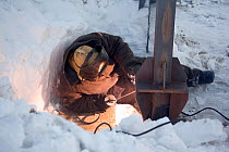A welder working in the gas fields at Sabetta near Tambey, Yamal Peninsula, Western Siberia, Russia, March 2011