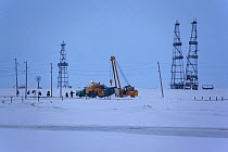 Gas drilling derricks and workers at Sabetta in the Tambey gas field. Yamal Peninsula, Western Siberia, Russia, march 2011