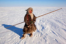 Natasha Serpevo, a Nenets reindeer herder, out checking her family's reindeer at their winter pastures on the tundra near Tambey. Yamal Peninsula, Western Siberia, Russia, March 2011