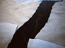 Aerial view of pancake ice sheet cracking and melting in Hudson Bay, Manitoba, Canada, December 2004