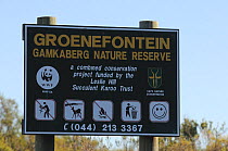 Sign at Gamkaberg Nature Reserve forbiding picking flowers, shooting and making fire. Little Karoo, Western Cape, South Africa, May 2011.