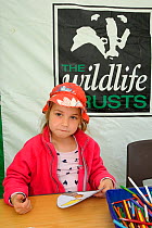 Child making Osprey masks at Lyndon Visitor Centre, Rutland Water, Rutland, UK, April 2011