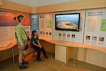 Visitors to Lyndon Visitor Centre watching Osprey nest on the live web cam, Rutland Water, Rutland, UK, April 2011