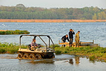 Reserve Manager Tim Appleton, Osprey Project Manager Tim Mackrill, Field Officer John Wright and Assistant Warden Lloyd Park check nesting islands and rafts at the Anglian Birdwatching Centre, using a...