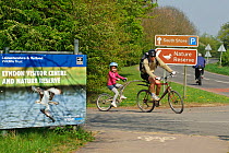 Cyclists, adult and child on double bicycle at Lyndon Visitor Centre, Rutland Water, Rutland, UK, April 2011. 2020VISION Book Plate.