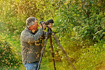 Terry Whittaker photographing swarm of Greenfly (winged aphids), Rutland Water, Rutland, UK, April 2011