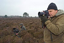 Photographer David Tipling and Will Bolton at work photographing and filming the heathland for 2020VISION on Dunwich Heath National Trust reserve in Suffolk, February 2011. Model released