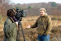Will Bolton filming interview with 2020VISION photographer David Tipling, Westleton Heath, Minsmere RSPB reserve, Suffolk, UK, February 2011. Model released
