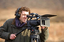 Will Bolton, 2020VISION videographer, filming at Westleton Heath, Minsmere RSPB reserve, Suffolk, UK, February 2011.