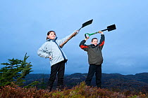 Children from Lochinver primary school planting trees on moorland at Culag Wood, Sutherland, Highlands, Scotland, UK, January 2011. Photographer quote: 'Getting out of the classroom, even on a cold, c...