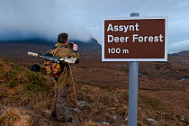Don o'Driscoll, JMT, with spoof Deer Forest sign, Quinag, Sutherland, Highland, Scotland, UK, January 2011