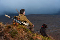 Don o'Driscoll, JMT, looking out over the moorland, with dog, Quinag, Sutherland, Highland, Scotland, UK, January 2011. 2020VISION Exhibition. 2020VISION Book Plate.
