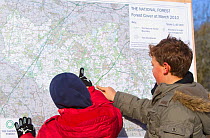 Two boys looking at map of The National Forest, Moira, Derbyshire, UK, November 2010