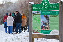 Volunteers in snow, ready to plant sapling trees as part of The National Forest's planting day, Moira, Derbyshire, UK, November 2010