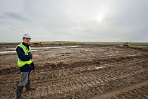 RSPB Project Manager Dave Hedges at site. Wetland habitat ecosytem creation for the RSPB by Breheny Civil Engineers at Bowers Marsh RSPB Reserve, Thames Estuary, Essex, UK. November 2011.  Model relea...