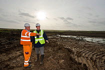 RSPB Project Manager Dave Hedges and machine operator Alan Deval. Wetland habitat ecosytem creation for the RSPB by Breheny Civil Engineers at Bowers Marsh RSPB Reserve, Thames Estuary, Essex, UK. Nov...