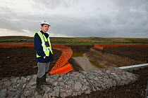 RSPB Project Manager Dave Hedges at the new water vole habitat. Wetland habitat ecosytem creation for the RSPB by Breheny Civil Engineers at Bowers Marsh RSPB Reserve, Thames Estuary, Essex, UK. Novem...