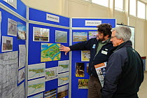 An event to introduce the local community to the RSPB Wallasea Wild Coast Project. Project manager, Chris Tyas, explains the project to a visitor and the plans for the future of Wallasea Island, Essex...