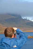Photographer Mark Hamblin photographing Old Man of Storr, Skye, Inner Hebrides, Scotland, UK, January 2011, model released
