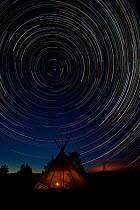 Star trails in a South Dakota sky over a Ogallala Lakota Sioux teepee. USA, April.