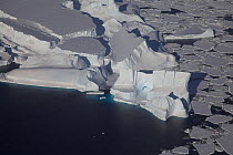 Aerial view of caved icebergs holding pack ice, Antarctica, March 2011.