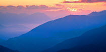 Sun rising over mountain landscape at dawn. Nordtirol, Tirol, Austrian Alps, Austria, July.