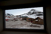 View out of hut window of McMurdo station in early spring light, Ross Island, Antarctica, October 2009. Taken on location for BBC series, Frozen Planet, Winter